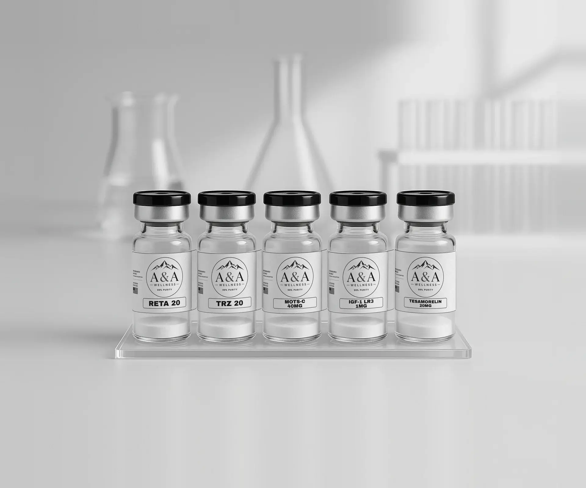 Five A&A Wellness research peptide vials on a clear acrylic riser with lab glassware and a test tube rack in the background