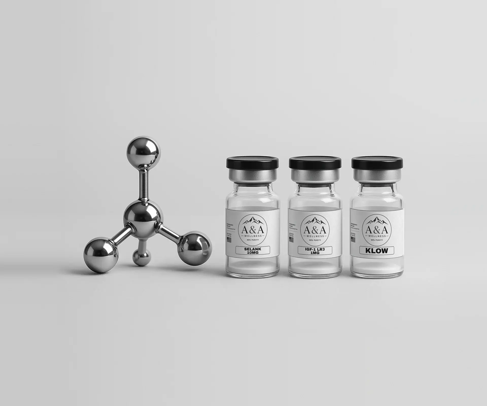 Chrome molecule model beside three A&A Wellness research vials on a white surface